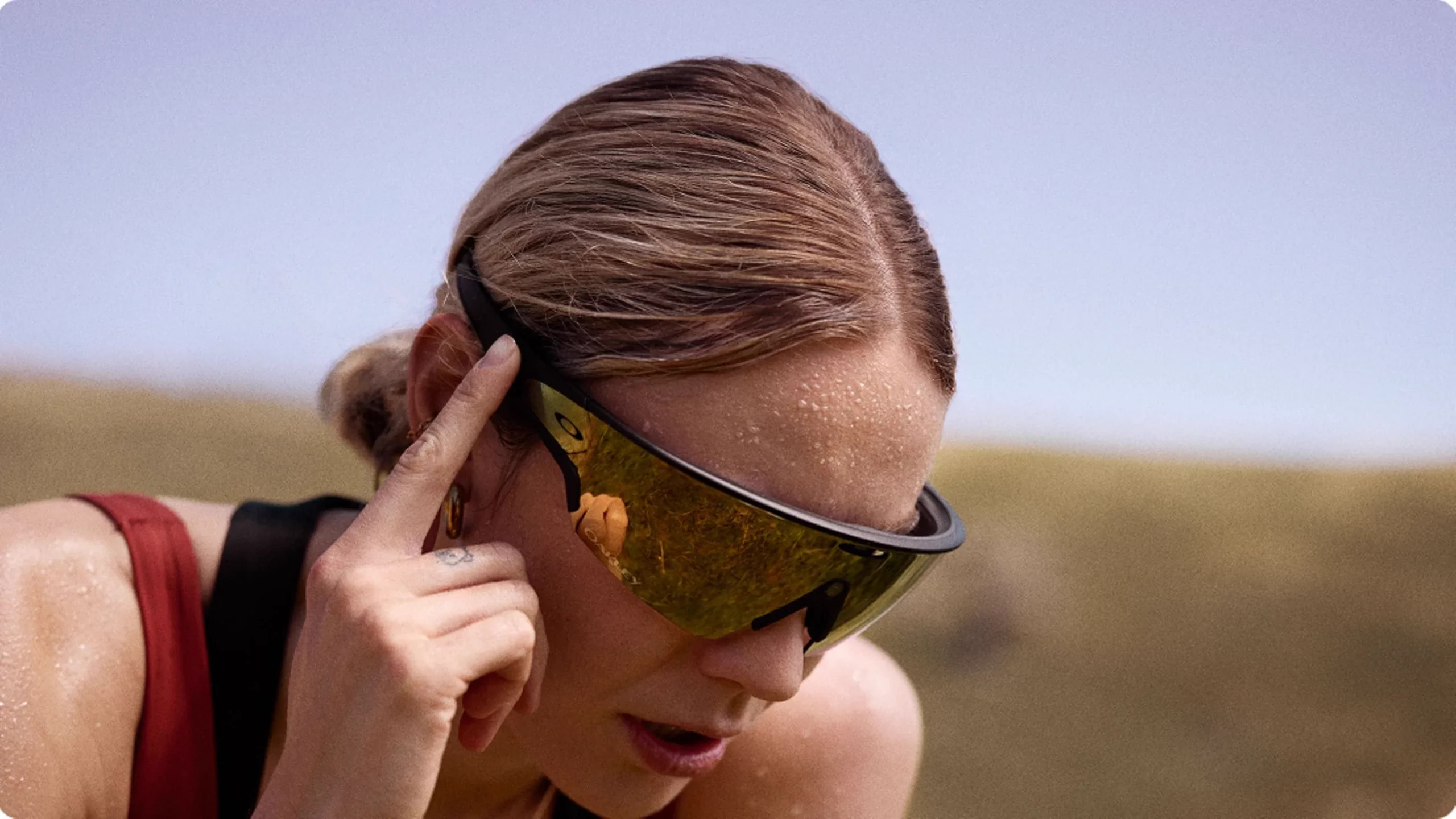 Runner wearing Oakley Meta Vanguard glasses and using the side controls after exercise