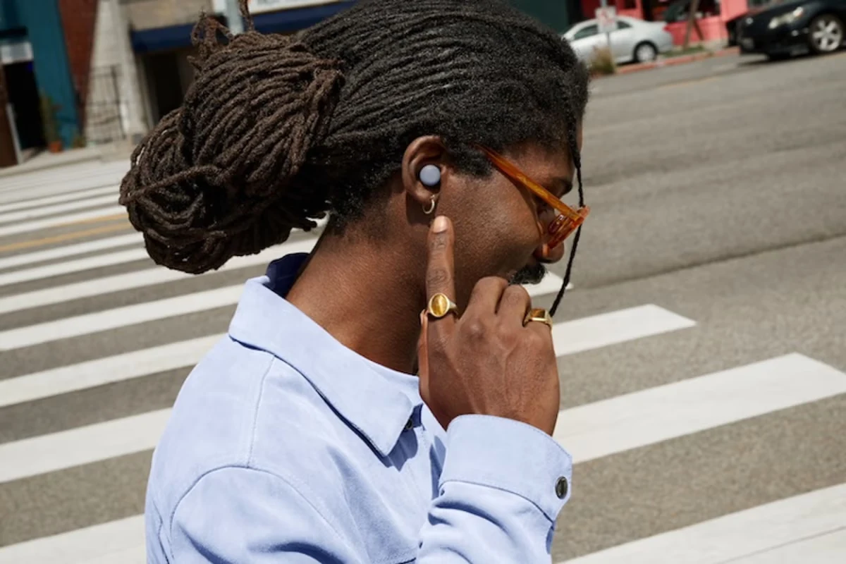 Person wearing a Moonstone Google Pixel Buds Pro 2 earbud outdoors