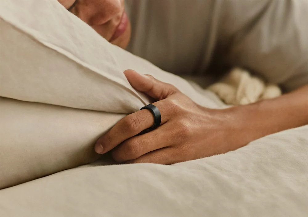 Person wearing a black Samsung Galaxy Ring while sleeping