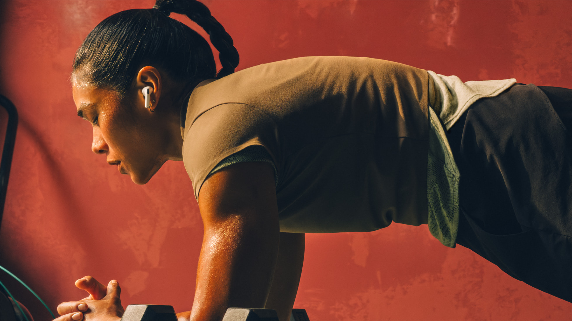 A runner wearing Apple AirPods Pro 3 during a workout