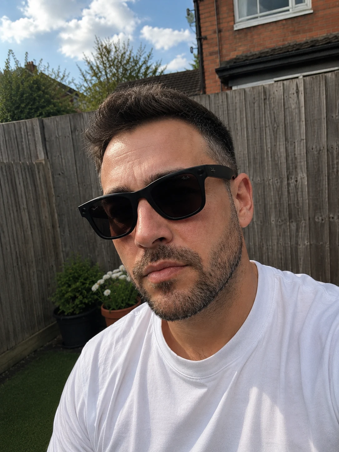 Wearing Ray-Ban Meta Gen 2 Wayfarer glasses outdoors in a white T-shirt